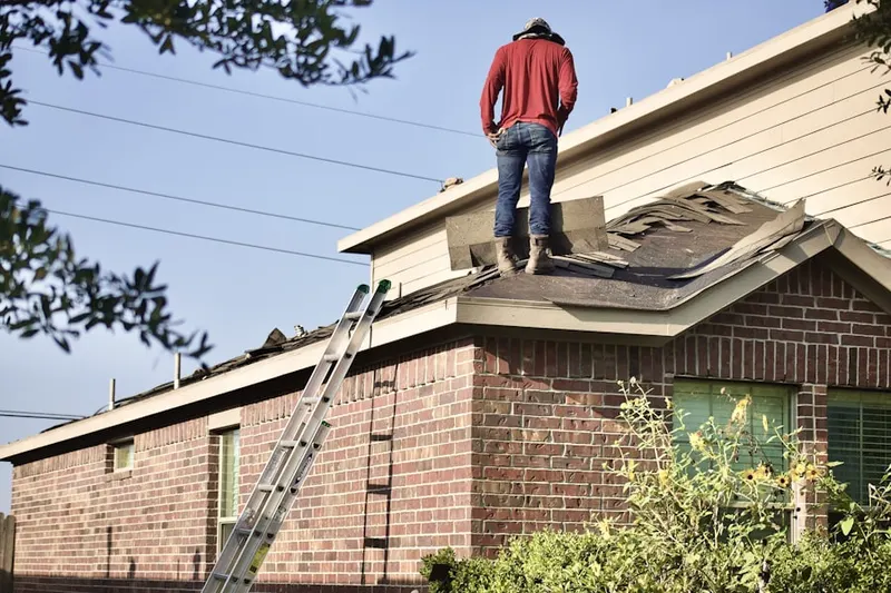 Professional roofer working on a residential roof in Lower Roseville